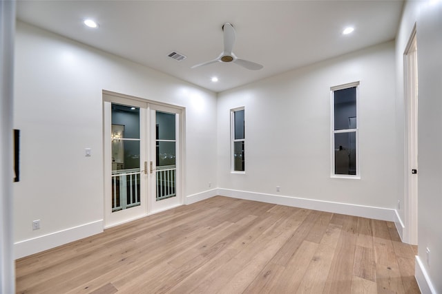 empty room featuring baseboards, visible vents, ceiling fan, and light wood-style flooring