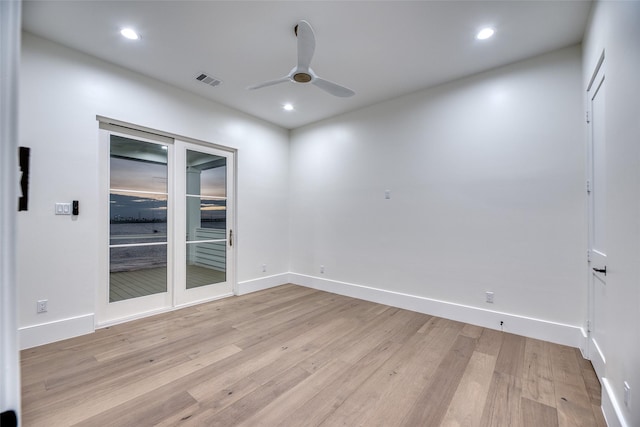 spare room with recessed lighting, light wood-style flooring, ceiling fan, baseboards, and visible vents