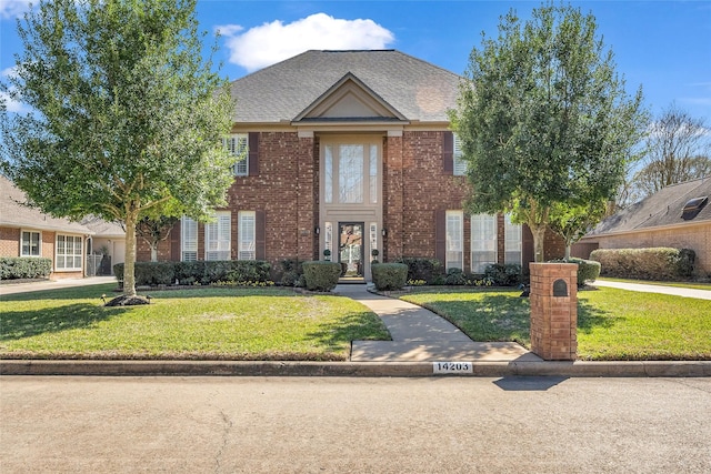 14203 Verde Mar Ln, Houston, TX 77095 - view of front of property with a front lawn, brick siding, and roof with shingles