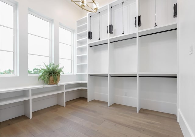 426 81st St, Galveston, TX 77554 - interior space with an inviting chandelier and light wood finished floors