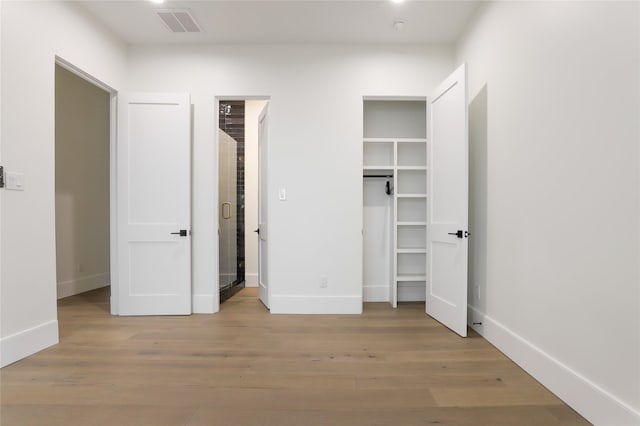 426 81st St, Galveston, TX 77554 - unfurnished bedroom with baseboards, visible vents, and wood finished floors