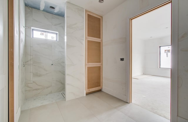 6510 Sivley St, Houston, TX 77055 - bathroom featuring healthy amount of natural light and a marble finish shower