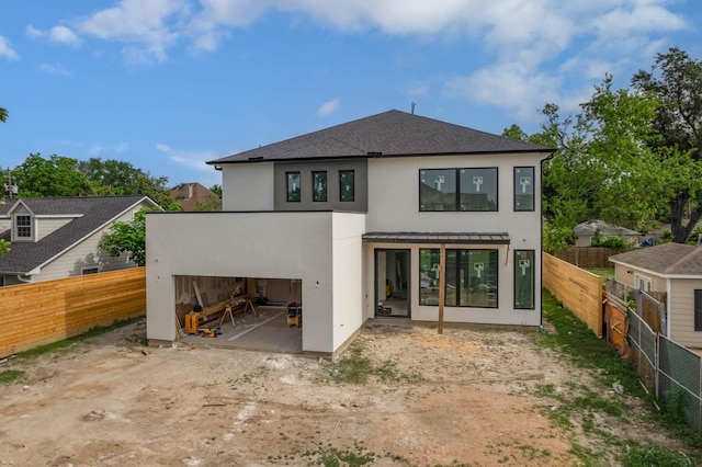6510 Sivley St, Houston, TX 77055 - back of property featuring stucco siding, a patio area, a fenced backyard, and a shingled roof