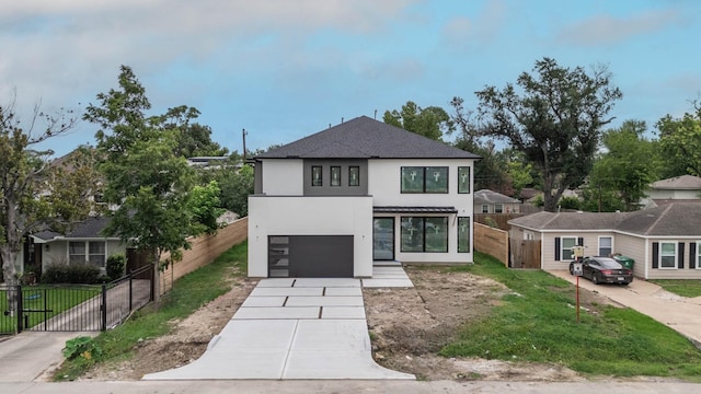 6510 Sivley St, Houston, TX 77055 - contemporary house with stucco siding, concrete driveway, an attached garage, a gate, and a shingled roof