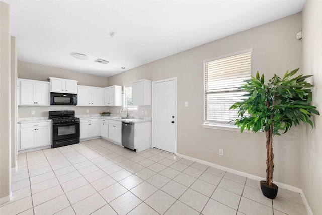 kitchen featuring black appliances, baseboards, white cabinetry, and light countertops