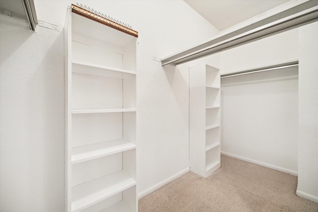 walk in closet with carpet floors