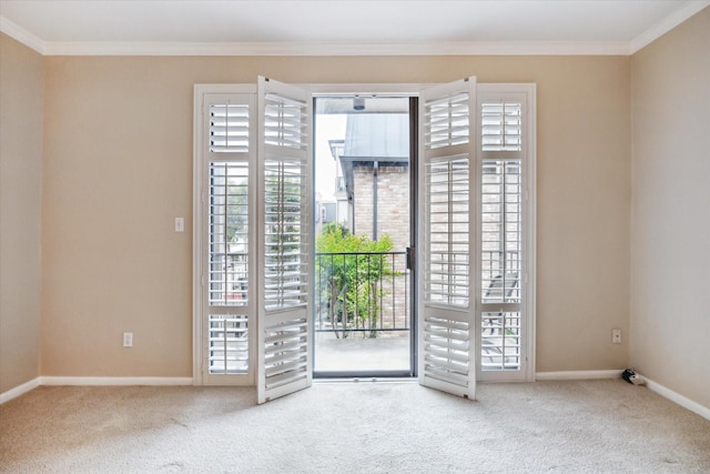 doorway to outside featuring baseboards, carpet floors, crown molding, and plenty of natural light