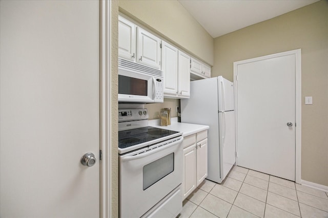kitchen featuring light tile patterned floors, light countertops, white cabinetry, and white appliances
