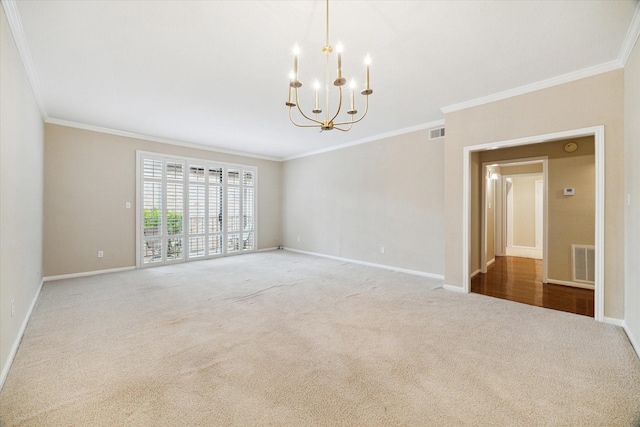 unfurnished room with crown molding, visible vents, a chandelier, baseboards, and carpet