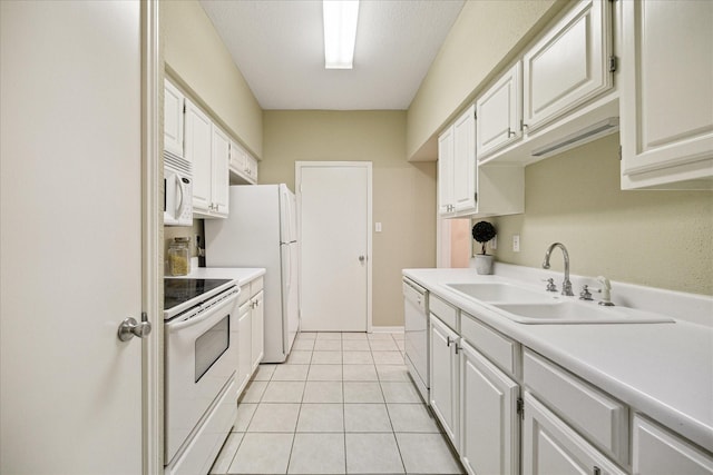 kitchen featuring white cabinetry, white appliances, light countertops, and a sink