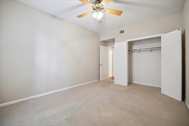 unfurnished bedroom featuring a closet, a ceiling fan, visible vents, baseboards, and light colored carpet