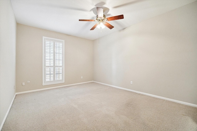 unfurnished room with a ceiling fan, carpet flooring, and baseboards