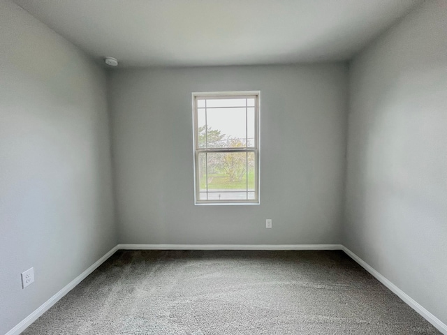 312 N Orange St, Sweeny, TX 77480 - empty room featuring carpet floors, baseboards, and a smoke detector