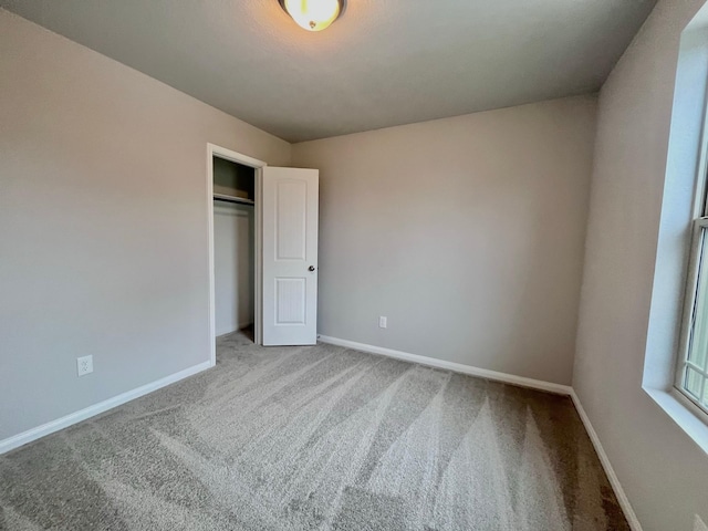 312 N Orange St, Sweeny, TX 77480 - unfurnished bedroom with carpet, baseboards, and a closet