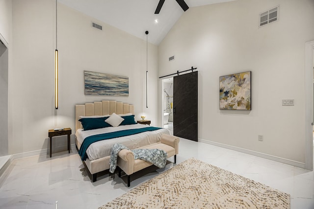 bedroom with visible vents, a barn door, and marble finish floor