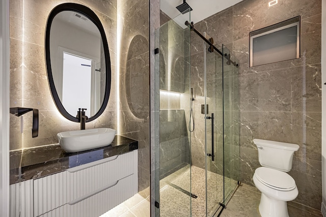 full bathroom with a shower stall, toilet, and tile walls