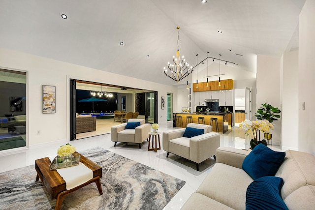 living area with recessed lighting, baseboards, a notable chandelier, and high vaulted ceiling