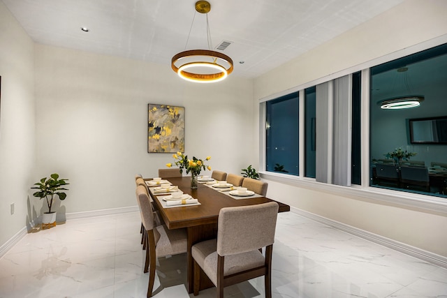 dining area featuring baseboards, marble finish floor, and visible vents