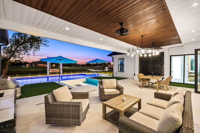 view of patio / terrace with ceiling fan, an outdoor living space, and an outdoor pool