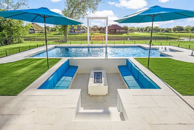 view of pool with a lawn, fence, a fenced in pool, and a fire pit