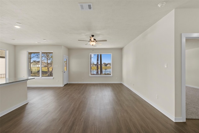 457 Shoreview Dr, Conroe, TX 77303 - unfurnished living room with baseboards, visible vents, a ceiling fan, and dark wood-style flooring