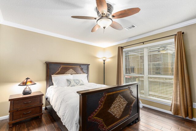 bedroom with crown molding, baseboards, visible vents, and dark wood-type flooring