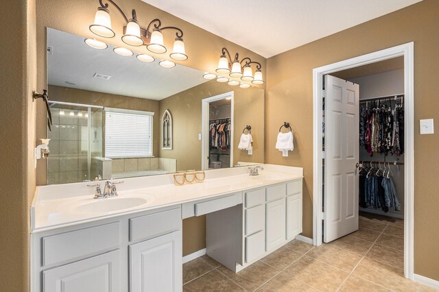full bathroom with a sink, tile patterned floors, a stall shower, and double vanity