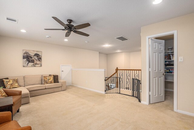 living area featuring carpet floors, a ceiling fan, visible vents, and recessed lighting