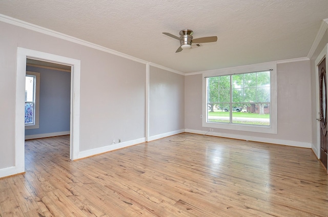 spare room featuring crown molding, ceiling fan, light wood-style flooring, and baseboards