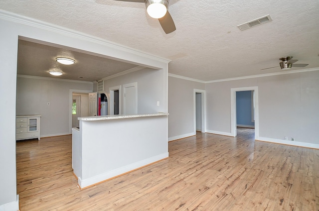 unfurnished living room with a ceiling fan, visible vents, and light wood-style flooring