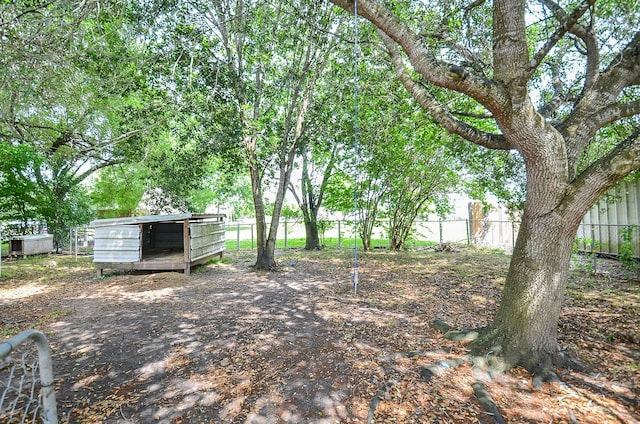 view of yard with mail area and fence