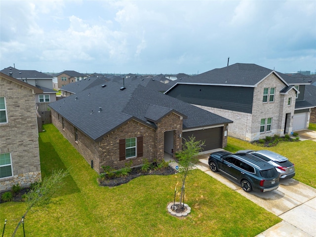 traditional-style home featuring a front yard, a garage, a shingled roof, driveway, and brick siding