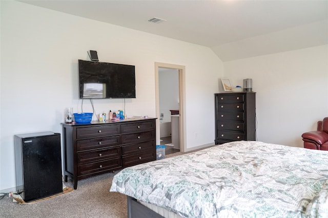 carpeted bedroom featuring visible vents and vaulted ceiling