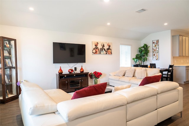living area with lofted ceiling, wood finished floors, visible vents, and recessed lighting