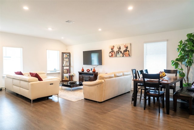 living room with dark wood-style flooring, visible vents, a healthy amount of sunlight, and recessed lighting