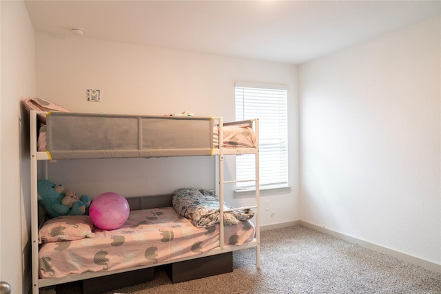 bedroom with carpet and baseboards