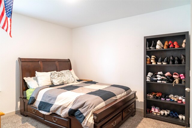 carpeted bedroom featuring baseboards