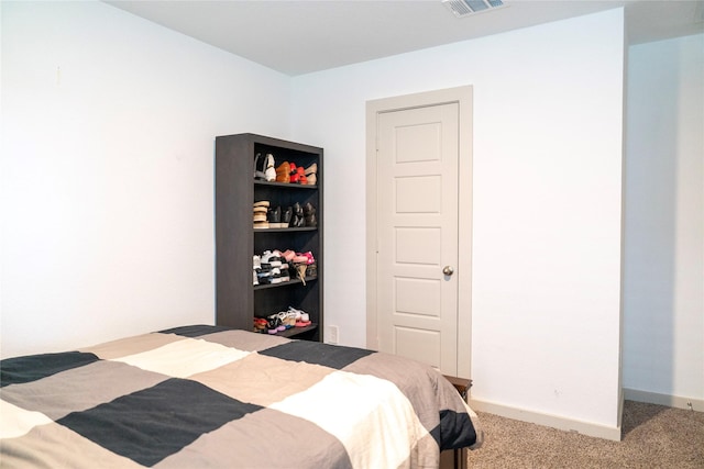 bedroom with baseboards, visible vents, and carpet flooring