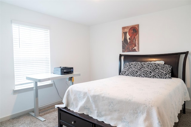 carpeted bedroom featuring baseboards