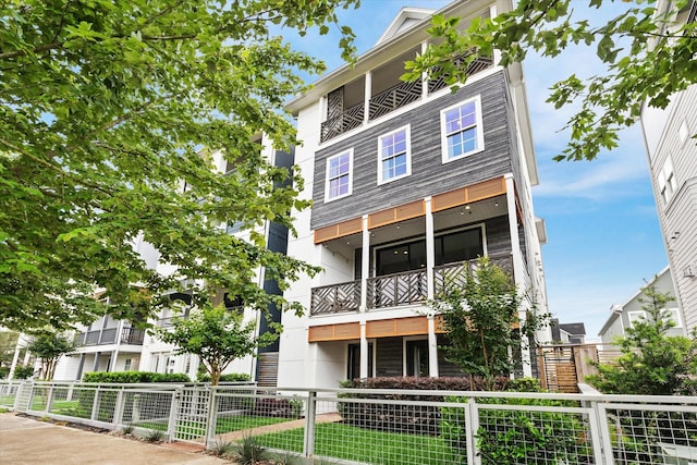 exterior space with fence private yard and a balcony