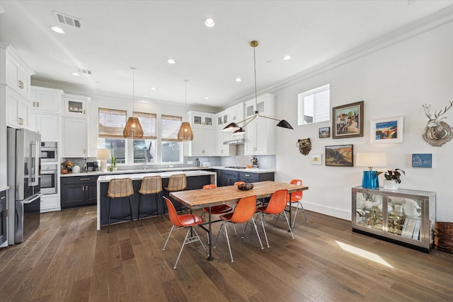 dining room with visible vents, dark wood-style flooring, crown molding, and recessed lighting