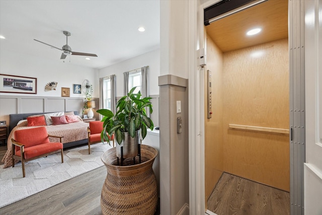 interior space featuring recessed lighting, wood finished floors, ceiling fan, and elevator
