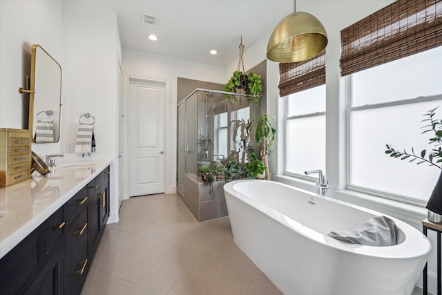 full bathroom with vanity, a stall shower, visible vents, tile patterned flooring, and a soaking tub