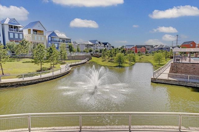 view of water feature featuring fence and a residential view