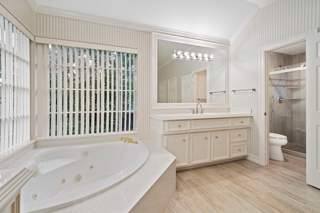 bathroom featuring a shower stall, toilet, vanity, crown molding, and a jetted tub