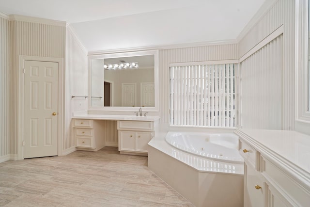 bathroom with a tub with jets and vanity