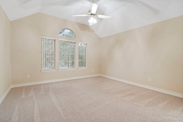 empty room featuring ceiling fan, baseboards, vaulted ceiling, and carpet floors