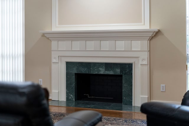 interior details with wood finished floors and a fireplace