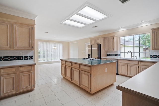 kitchen with appliances with stainless steel finishes, backsplash, and a sink