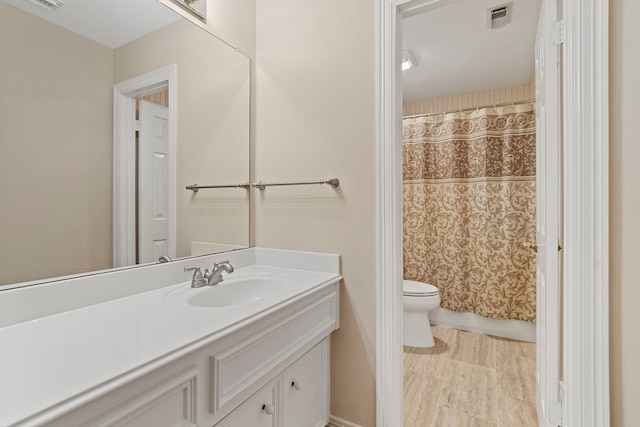 full bathroom with visible vents, toilet, and vanity